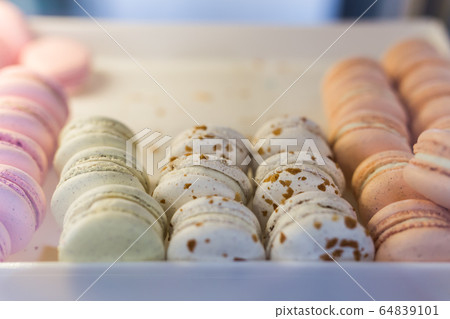 A french sweet delicacy, macaroons variety close-up on a showcase A french sweet delicacy, macaroons variety close-up on a showcase 64839101