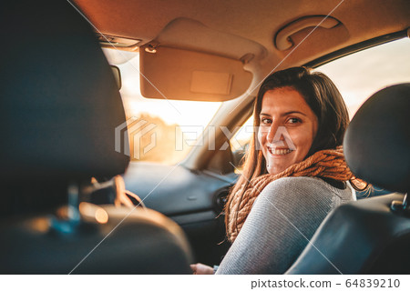 Portrait of a young woman on the frontseat of a Portrait of a young woman on the frontseat of a 64839210