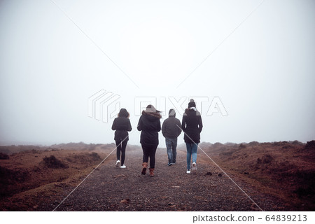 Four people hiking with fog 64839213