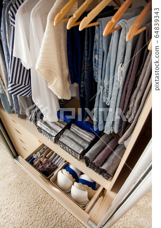 Neatly folded things and accessories in boxes 64839343