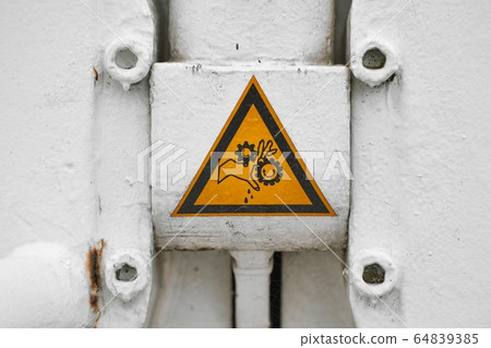 Warning sign on heavy machinery Warning sign on heavy machinery 64839385