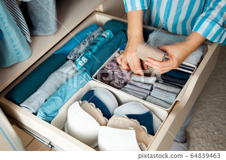 Unidentified neat housewife puts container Unidentified neat housewife puts container 64839463