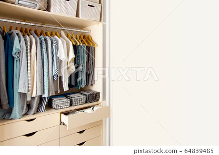 Wardrobe with perfect order clothes shades. Copy space. 64839485