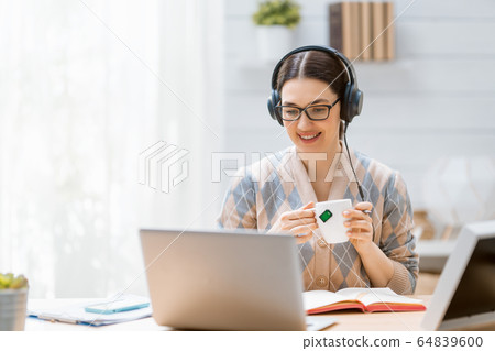 Woman working on a laptop. Woman working on a laptop. 64839600