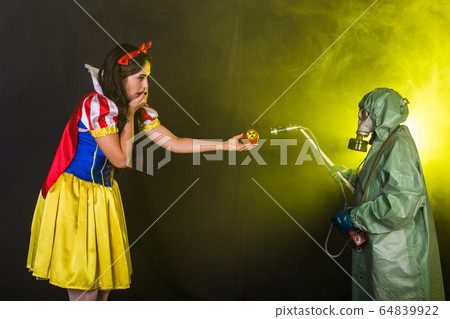 Danger, nuclear and radiation measurement - Girl holds apple with radiation hazard symbol. Danger, nuclear and radiation measurement - Girl holds apple with radiation hazard symbol. 64839922