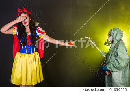 Danger, nuclear and radiation measurement - Girl holds apple with radiation hazard symbol. Danger, nuclear and radiation measurement - Girl holds apple with radiation hazard symbol. 64839923