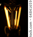 incandescent lamp on a dark background.close-up 64841659