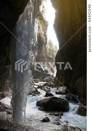 Snow-covered icicles at Partnachklamm, famous tourist destination. 64842046