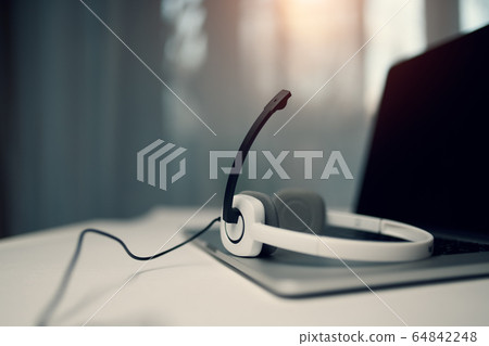 laptop with black screen, headphones, microphone on table on blurred window background. laptop with black screen, headphones, microphone on table on blurred window background. 64842248