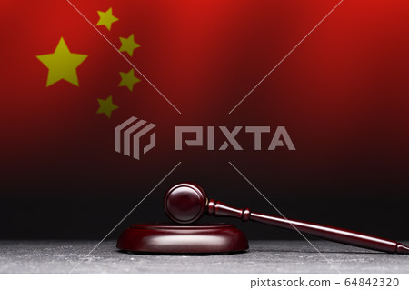 Judge's gavel on background of flag of China. Judge's gavel on background of flag of China. 64842320