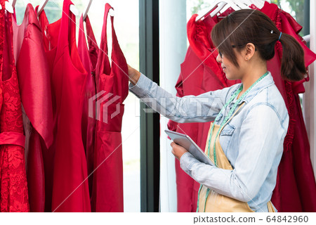 Happy young Asian woman dressmaker fashion Happy young Asian woman dressmaker fashion 64842960