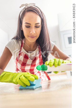 Young housewife leaning above the desk being Young housewife leaning above the desk being 64843413