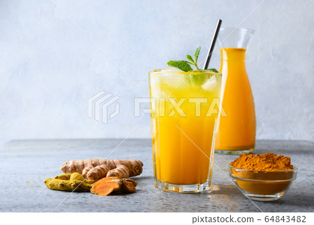 Golden milk turmeric iced latte. Ayurvedic drink Golden milk turmeric iced latte. Ayurvedic drink 64843482