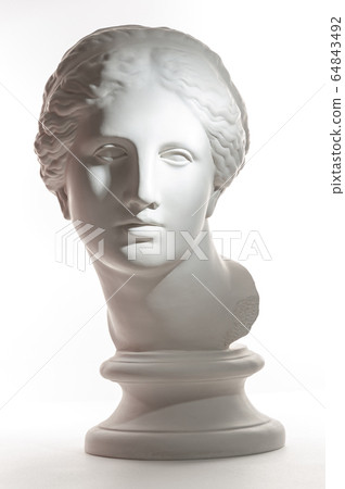 Gypsum copy of ancient statue Venus head isolated on white background. Plaster sculpture woman face. 64843492