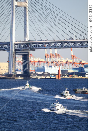 Three tugboats passing under the Bay Bridge all at once 64843583