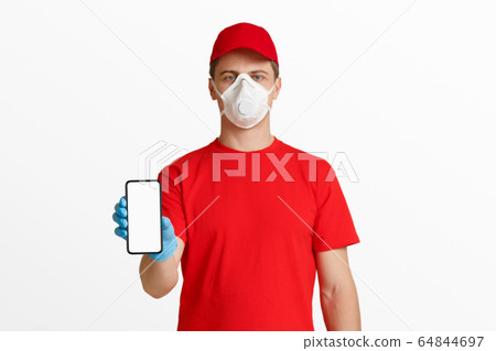 Phone with empty space in hand of courier in red uniform Phone with empty space in hand of courier in red uniform 64844697