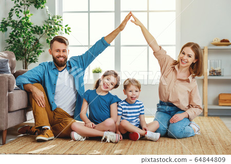 Happy parents making roof with hands while sitting 64844809