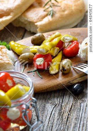 Greek snack: Cherry peppers and chillies stuffed with cheese, served with olives and pita bread Greek snack: Cherry peppers and chillies stuffed with cheese, served with olives and pita bread 64845677