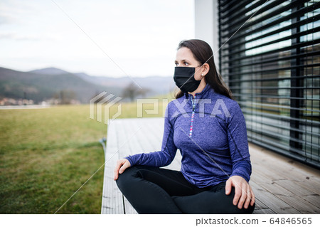 Woman with face masks outdoors at home, Corona virus and quarantine concept. 64846565