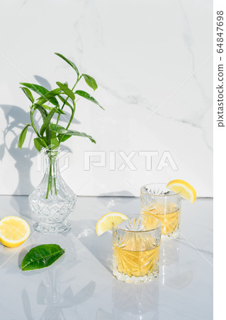 Two crystal glasses with yellow cocktails 64847698