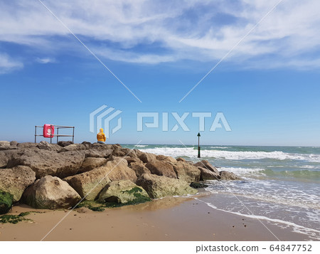 Back view woman in bright yellow coat sitting Back view woman in bright yellow coat sitting 64847752