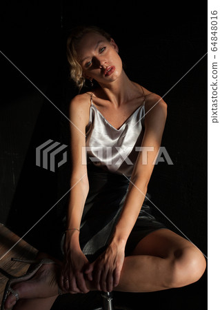 portrait of a beautiful fashionable blonde woman in a blouse and black skirt portrait of a beautiful fashionable blonde woman in a blouse and black skirt 64848016