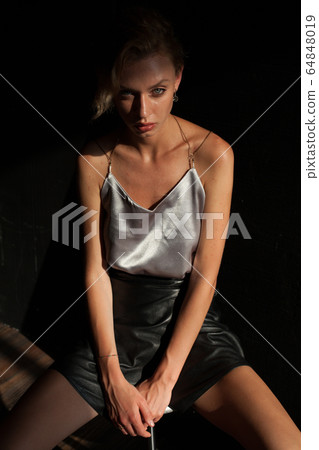 portrait of a beautiful fashionable blonde woman in a blouse and black skirt portrait of a beautiful fashionable blonde woman in a blouse and black skirt 64848019