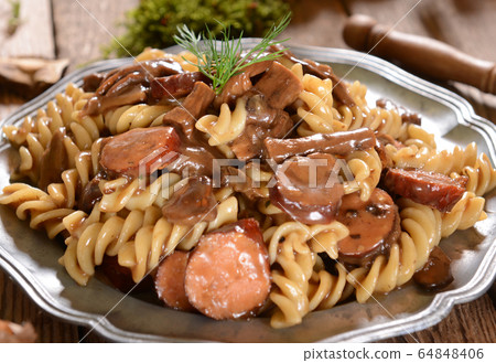 Fussili pasta with mushrooms and sausage Fussili pasta with mushrooms and sausage 64848406