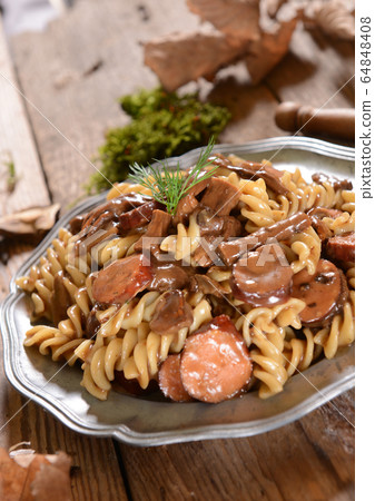 Fussili pasta with mushrooms and sausage Fussili pasta with mushrooms and sausage 64848408