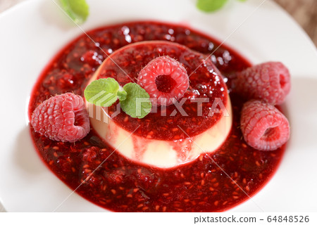 Panna cotta dessert with fresh raspberries and 64848526