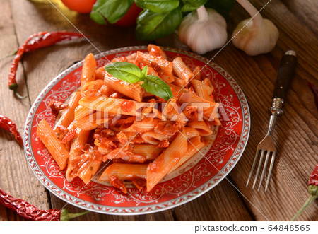 Penne pasta with hot chili sauce arrabiata Penne pasta with hot chili sauce arrabiata 64848565