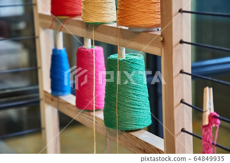 Rack of colorful yarn rolls for knitting Rack of colorful yarn rolls for knitting 64849935