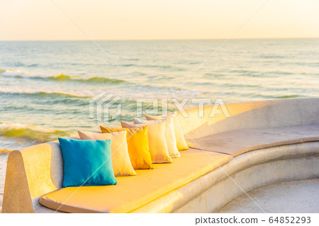 Comfortable pillow on sofa chair around outdoor patio with sea ocean beach view Comfortable pillow on sofa chair around outdoor patio with sea ocean beach view 64852293