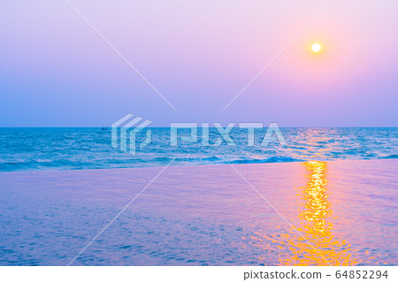 Beautiful tropical nature of sea ocean beach around outdoor swimming pool at sunset or sunrise time Beautiful tropical nature of sea ocean beach around outdoor swimming pool at sunset or sunrise time 64852294