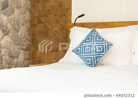 Comfortable white pillow on bed decoration in bedroom 64852312