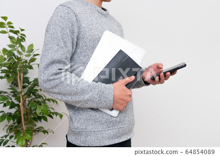 A man who operates a smartphone with one hand of PC 64854089