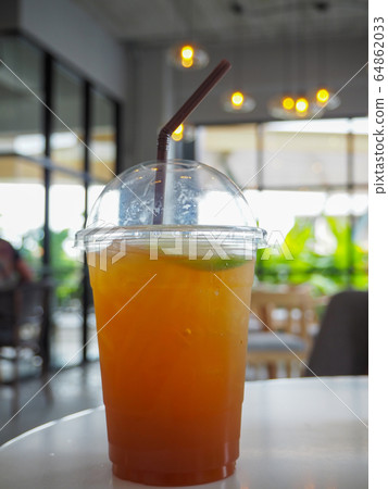 cold iced tea with lemon and straw in takeaway cold iced tea with lemon and straw in takeaway 64862033