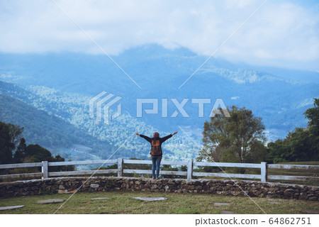 Happy Asian women Travel relax Standing at the view point Look at the watching the nature Happy Asian women Travel relax Standing at the view point Look at the watching the nature 64862751