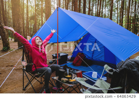 Women Nature tourism, camping in the middle of the pine forest. camping Women Nature tourism, camping in the middle of the pine forest. camping 64863429