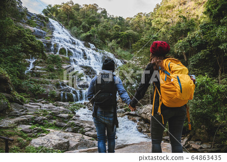 Travel relax to visit the waterfalls of couples at the waterfall mae ya chiangmai in thailand.  64863435
