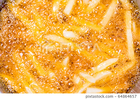 French fries on the pan, close up. Fried potatoes French fries on the pan, close up. Fried potatoes 64864657
