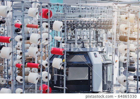 Textile Manufacturing. Circular knitted fabric. Textile factory in spinning production line and a rotating machinery and equipment production company. Clothing industry. Manufacturing textile fabrics. Textile Manufacturing. Circular knitted fabric. Textile factory in spinning production line and a rotating machinery and equipment production company. Clothing industry. Manufacturing textile fabrics. 64865330