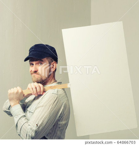 Working in a cap holding banner over his head Working in a cap holding banner over his head 64866703