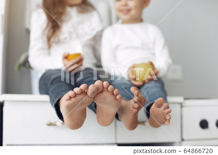 Children sitting in a kitchen at home 64866720
