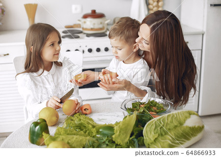 Family prepare the salad in a kitchen Family prepare the salad in a kitchen 64866933