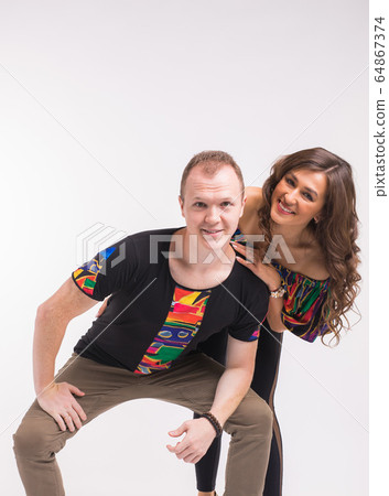 Funny couple dancing social dance. Kizomba or bachata or semba or taraxia , on white background. Social dance concept. 64867374