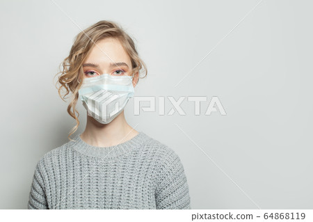 Cute woman wearing medical mask. Girl in a face 64868119