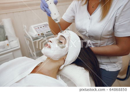 Woman in cosmetology studio on a procedures 64868850