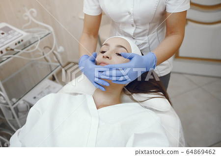 Woman in cosmetology studio on a procedures Woman in cosmetology studio on a procedures 64869462