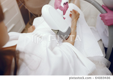 Woman in cosmetology studio on laser hair removal 64869486